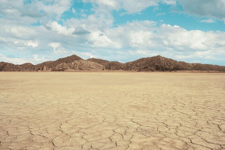 Cracked land with arid mountains.