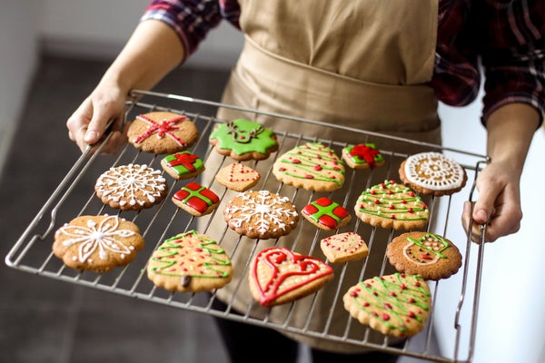 Young woman preparing gingerbread cookies