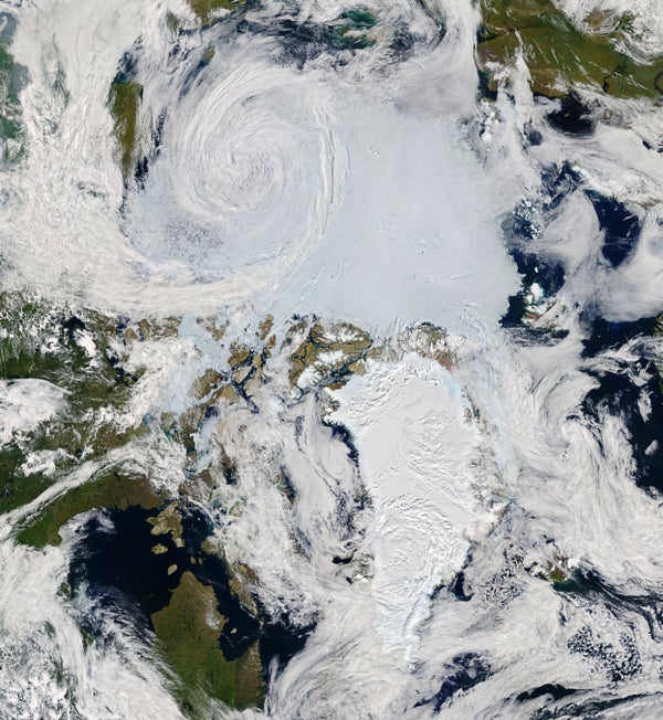 A NASA satellite image shows a cyclone spinning over the Arctic Ocean