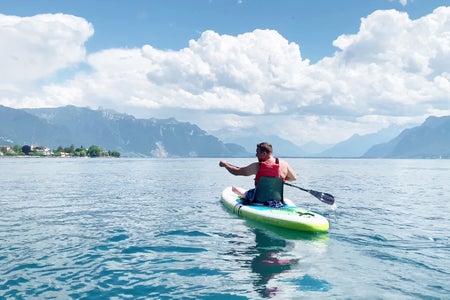 Man canoeing on lake.