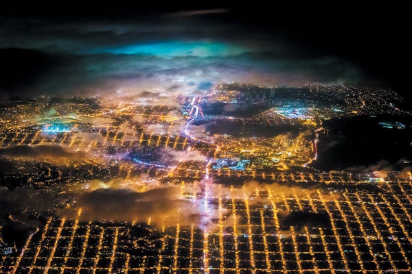 Colorful, moody aerial cityscape of the lights of San Francisco at night.