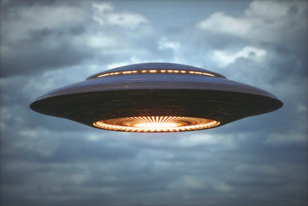 A flying saucer hovers in the sky.