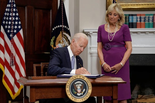 President Biden signing a law at White House