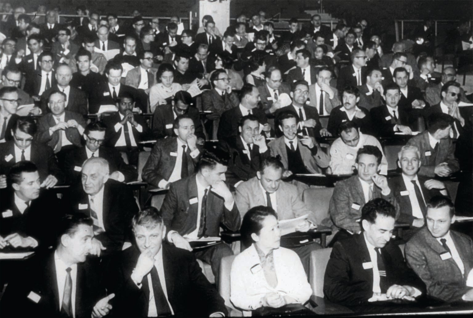 Chien-Shiung Wu sitting in the front row in auditorium seating with mostly male colleagues.