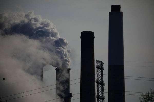 Emissions from smokestacks create a blackened sky.