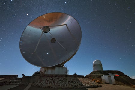 Large telescope against starry night sky