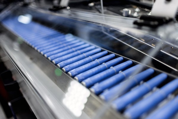 Blue injection pens move along a conveyor at the Novo Nordisk A/S production facilities.
