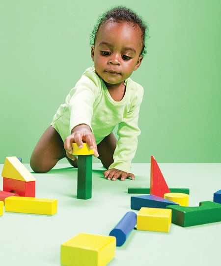 a baby playing with blocks