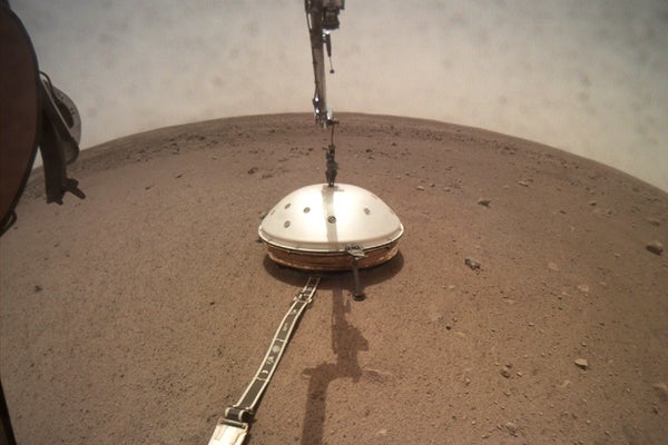 NASA's InSight lander deployed its Wind and Thermal Shield. In the wide lens image Insight's robotic arm and the dome-shaped shield