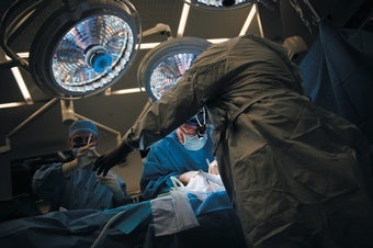 Surgeons lean over a patient during a kidney transplant at NYU Langone Health in New York City