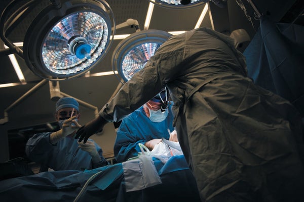 Surgeons performing surgery in operating room.