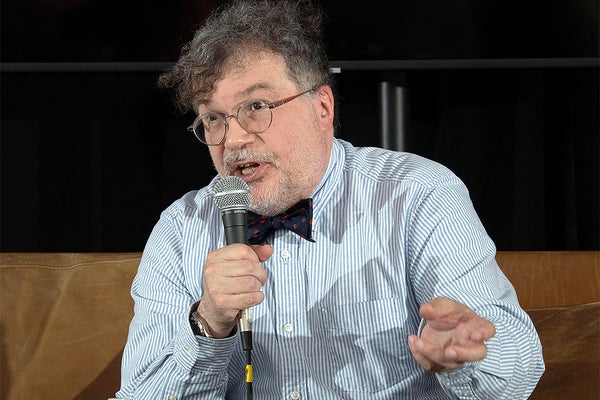 Peter Hotez holding a microphone and speaking