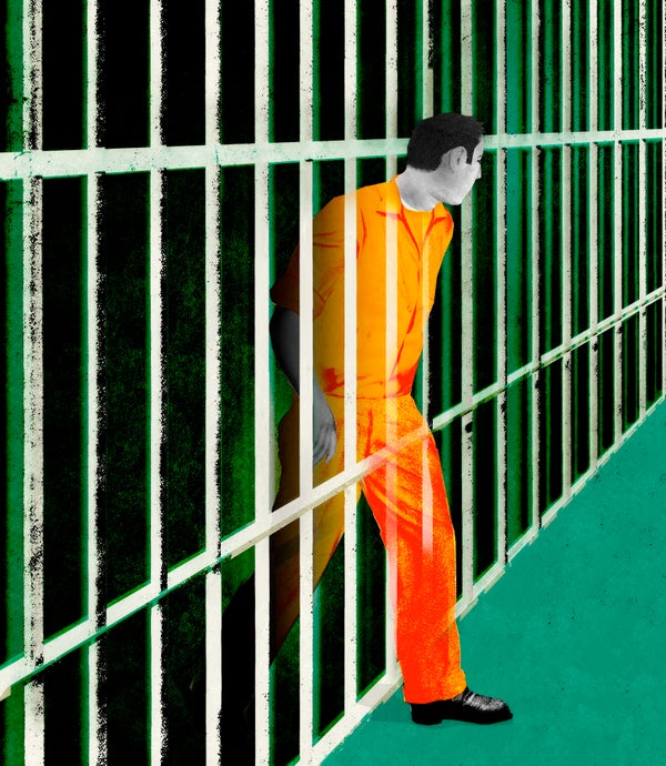 Prisoner in orange jumpsuit walking thru jail cell