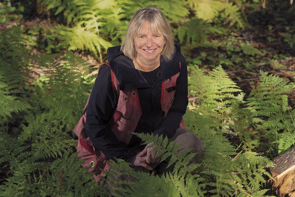 Author Suzanne Simard in a lush green forest.