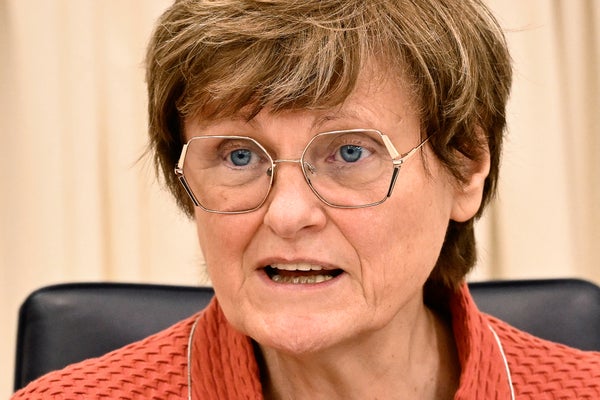 Dr. Katalin Kariko speaking while seated at a press conference