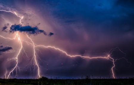 A panoramic view of lightning across the sky.