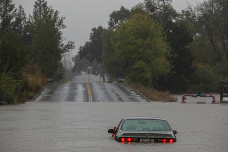 A vehicle sits in flood waters near the Russian River in Forestville, Calif., on Oct. 24, 2021 after an atmospheric river event drenched the area.