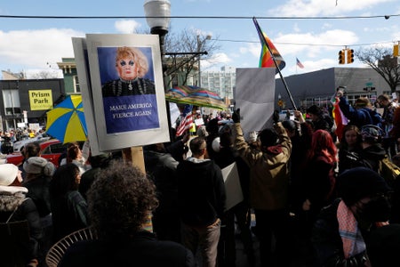 A crowd of demonstrators gather outside a bookstore