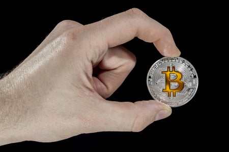 hand holding bitcoin