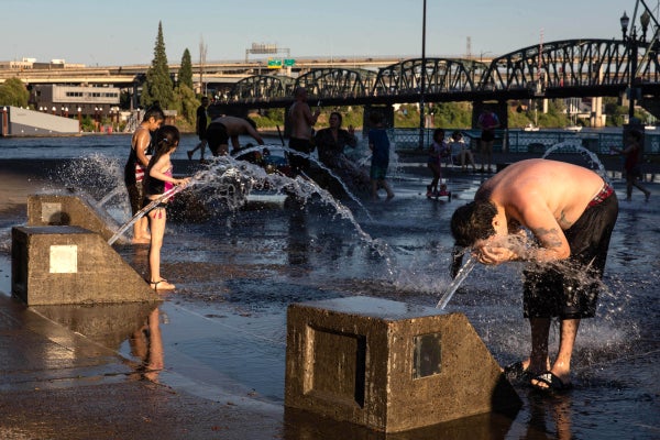 Residents cool off in a riverfront water fountain during a heatwave in Portland, Oregon, on June 26, 2021.
