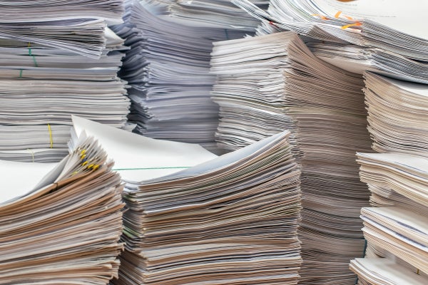 Piles of paper documents in the office