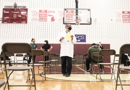 Medical staff oversee a COVID vaccination clinic in Detroit.
