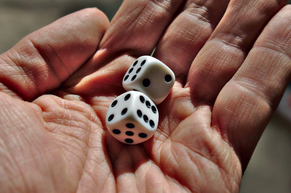 Man holding 2 black and white dice