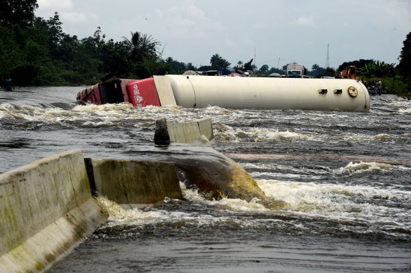 An overturned truck is shown in floodwaters in Nigeria.