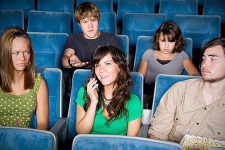 woman on phone during a movie