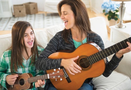 mother and daughter playing guitar