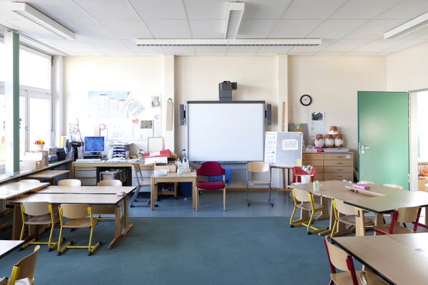 Empty classroom with chairs, blue floor and green door