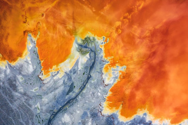 Aerial view of bright orange toxic waste water.