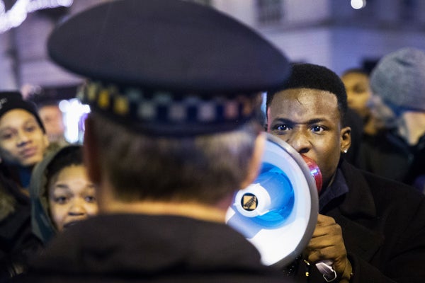 Demonstrators confront police during a protest over the death of Laquan McDonald on November 25, 2015 in Chicago, Illinois.