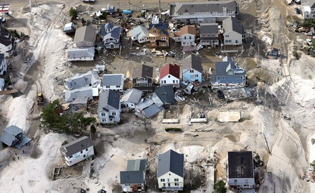 Homes wrecked by Superstorm Sandy sit amongst sand washed ashore on October 31, 2012 in Seaside Heights, New Jersey.