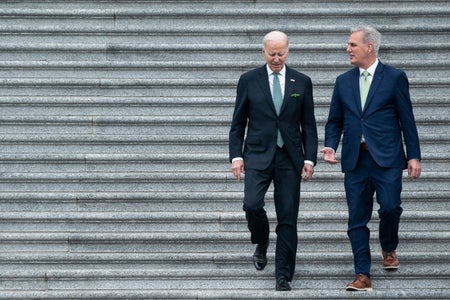 US President Joe Biden and Kevin McCarthy walking down stairs