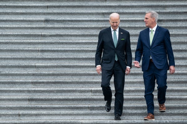 US President Joe Biden and Kevin McCarthy walking down stairs