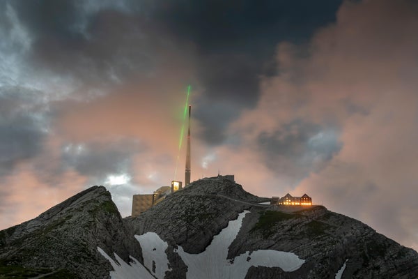 Mountaintop with laser beaming into sky
