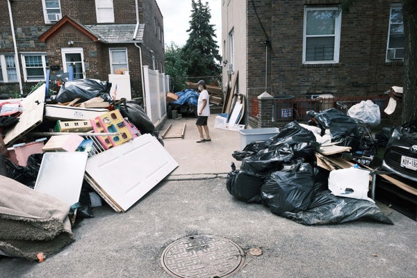 Person walking between homes damaged by hurrincane flooding..