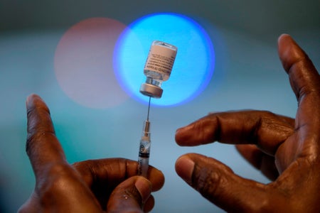 A healthcare worker prepares a dose of the BioNTech Covid-19 vaccine at a vaccination hub location in League City, Texas, February 5, 2021.