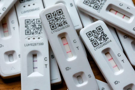 COVID-19 test strips showing positive results