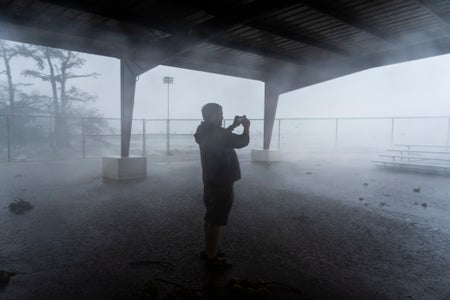 A person records rain and wind on his smartphone.