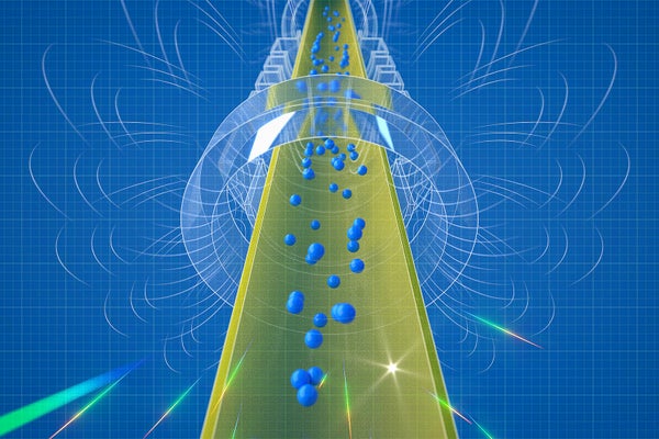 Small blue spheres representing antihydrogen atoms fall downward through a cylindrical apparatus