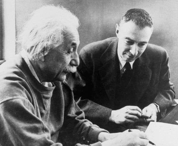 JRobert Oppenheimer sitting at table with Albert Einstein