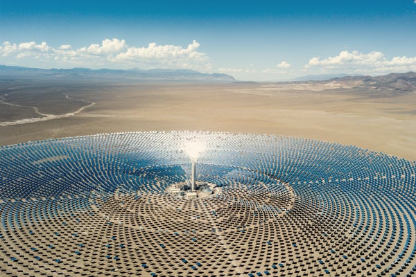Circular Solar Thermal Power Station in desert Aerial View with blue sky/clouds
