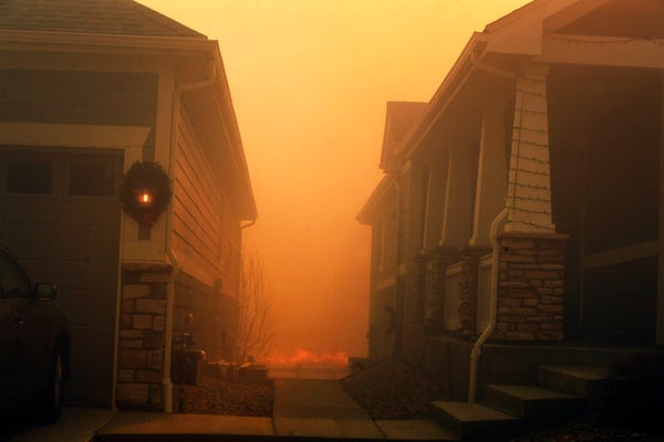 The Marshall Fire seen behind homes on December 30, 2021 in Superior, Colorado