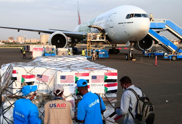 Aid workers check a shipment of vaccines at an airport in Sudan.