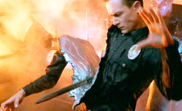 A still from the movie Terminator 2: Judgment Day, directed by James Cameron. Seen here, the right side of the T-1000 Terminator (played by Robert Patrick) is sliced through by a heavy metal rod.