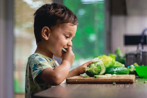 Little boy eating vegetables