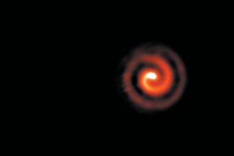 A spiral dust plume streams off the WR 104 binary-star system, as seen in infrared.