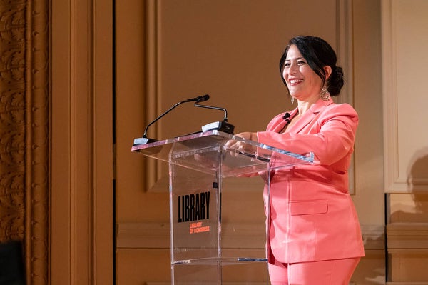 Ada Limón smiling at podium